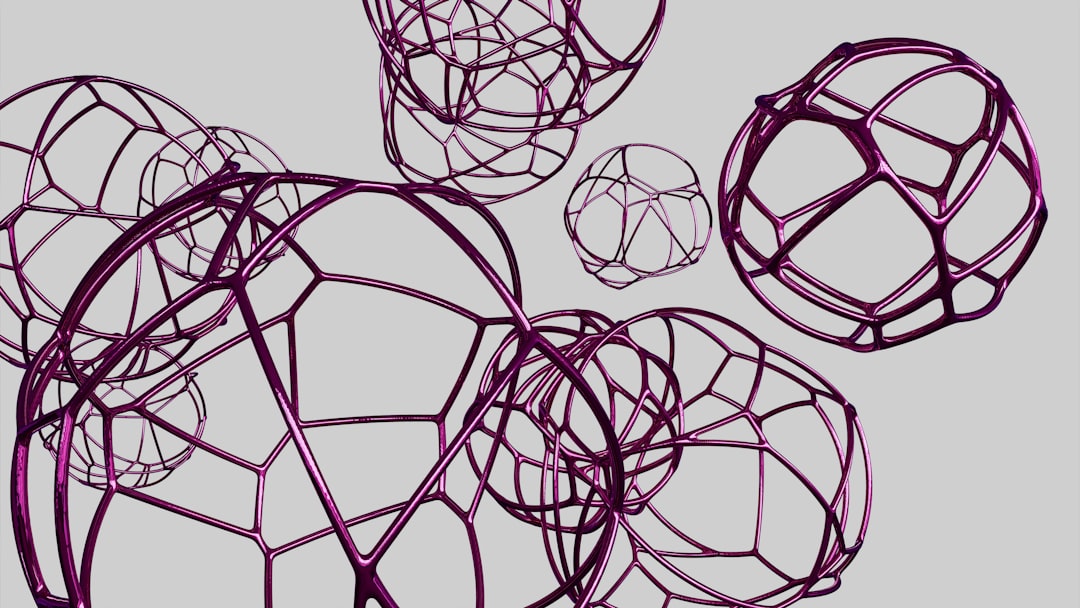 A series of abstract purple wireframe spheres floating against a gray background.